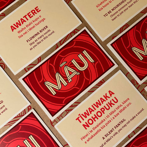 Assortment of Kaupapa Māui game cards with Māori and English words.