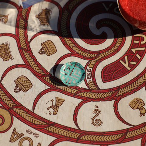 Detailed view of a Kaupapa game token on the board.