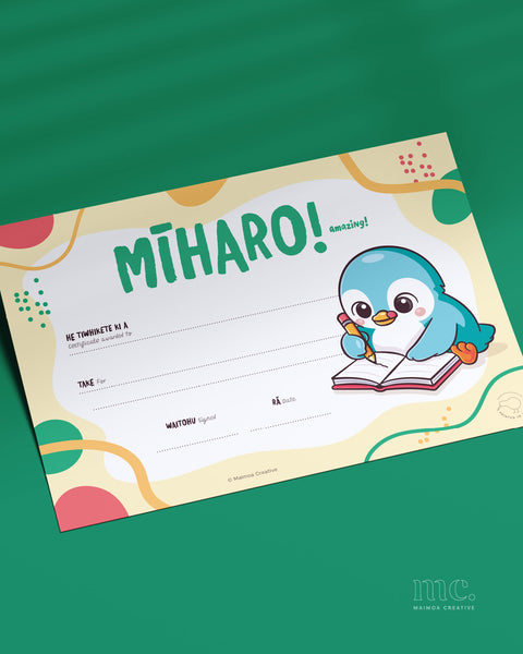 Mīharo amazing bilingual Māori classroom certificate for ECE and primary school – colourful student achievement award with kororā penguin illustration writing in a notebook