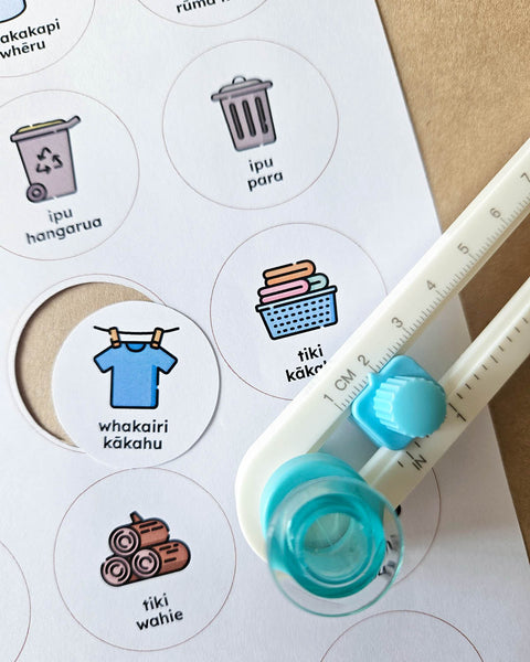 Round routine labels in te reo Māori with icons being cut out by a circle cutter tool