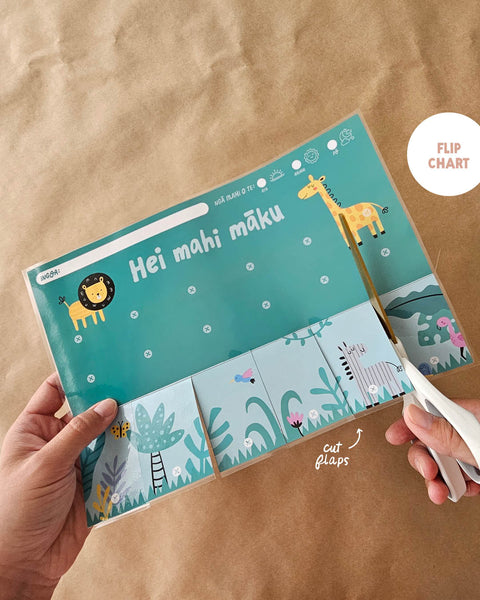 Cutting a Māori flip chart with zoo animal illustrations