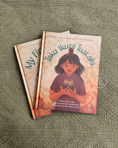 Two books titled 'My First Ikura' and 'Taku Ikura Tuatahi' by Qiane Matata-Sipu on a textured earthy green surface with Māori patterns