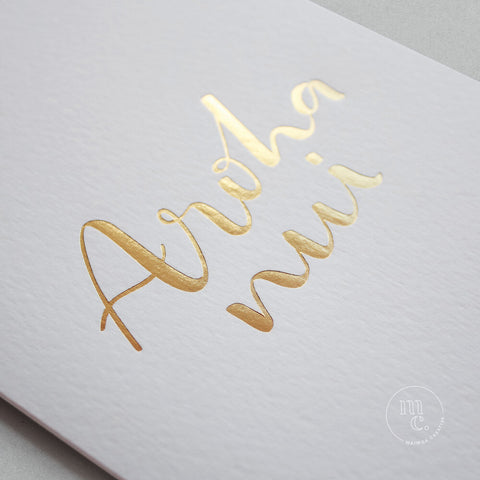 closeup of a premium reo Māori greeting card with 'Aroha nui' in gold foil lettering