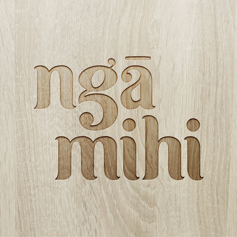 engraved maori inspired font in wooden surface saying 'ngā mihi'