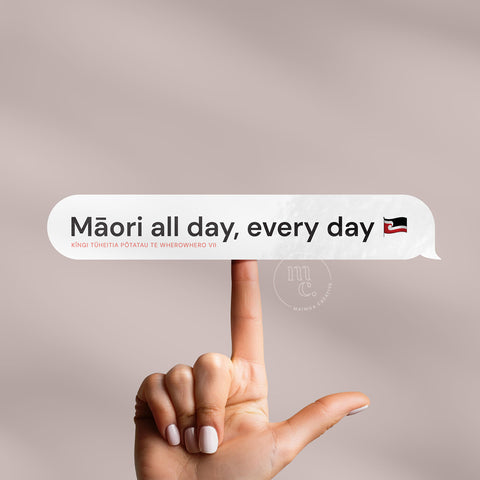 Finger balancing 'Māori all day every day' Māori vinyl sticker decal on a plain background, showcasing the phrase and the tino rangatiratanga flag