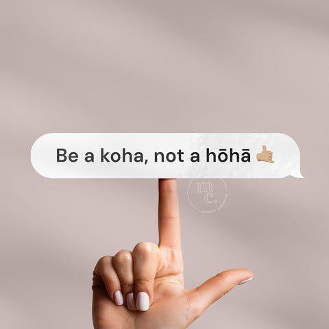 Finger balancing 'Be a koha, not a hōhā' Māori vinyl sticker decal on a plain background, showcasing the phrase and a shaka hand emoji
