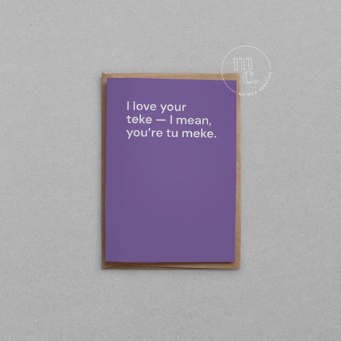 Greeting card with text 'I love your teke — I mean, you’re tu meke.' on a bright purple background, placed on a light surface