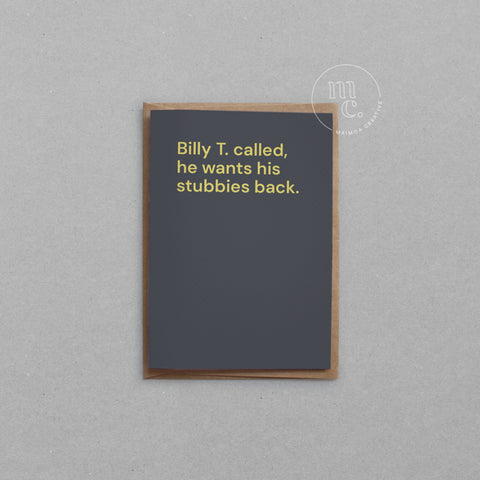 Greeting card with text 'Billy T. called, he wants his stubbies back' on a dark grey background, placed on a light surface