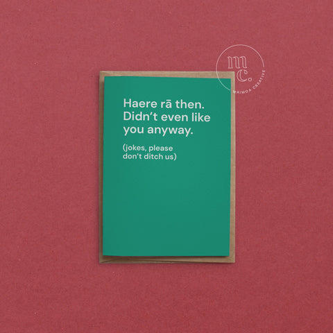 Greeting card with text 'Haere rā then, didn't even like you anyway' on a bright green background, placed on a bold red surface