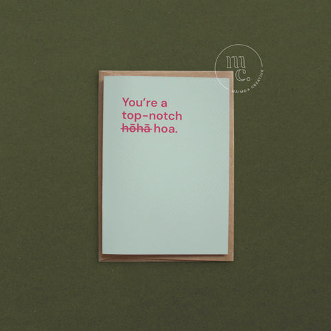 Greeting card with text 'You're a top notch hōhā/hoa' on a light mint green background, placed on a contrasting surface