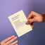 Person holding a humorous Māori apology card that says “Mō taku hē. Sorry for…” with funny checklist options, by Maimoa Creative.