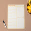 A3 yellow magnetic weekly planner with a whiteboard pen on a brown background