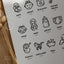 Closeup product image of a "Baby Vocab in Te Reo Māori" poster, featuring illustrations and translations of baby-related vocabulary