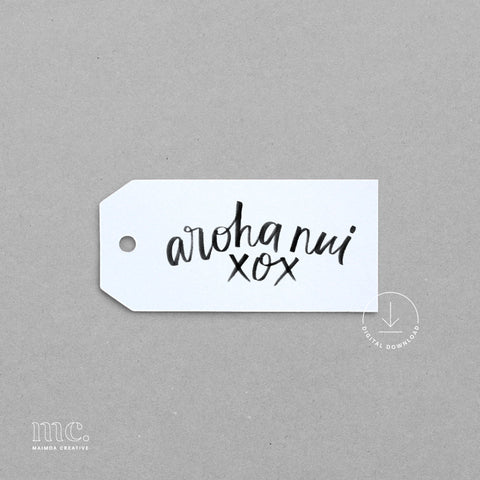 White tag with 'aroha nui xox' text on a gray background