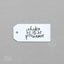 White tag with black text 'ahakoa he iti he pounamu' on a gray background