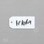 White gift tag with 'he koha' text on a gray background