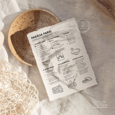 Flat lay of illustrated Parāoa Parai (fry bread) step-by-step recipe guide on linen, styled with natural textures in kitchen setting.