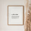 Framed 'uncle / matua kēkē' definition print with text on a white wall next to dried plants