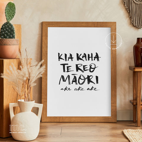 Framed poster with 'Kia Kaha Te Reo Maori' text in a home setting with decor elements.
