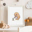 Framed illustration of a cartoon kiwi bird watering a fern on a shelf with decorative items.
