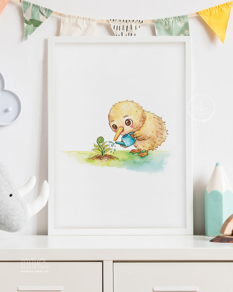 A framed print of a cute watercolour illustration of a fluffy kiwi chick gently watering a young fern frond