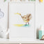 Framed watercolour illustration of a piwakawaka bird with a paintbrush flinging yellow paint