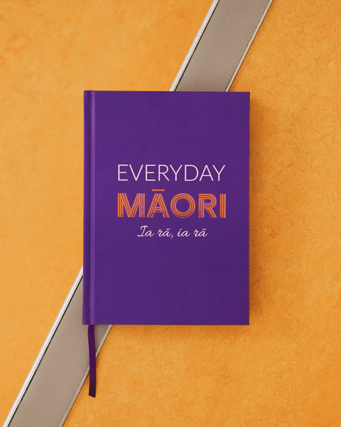 Purple book titled 'Everyday Maori ia rā ia rā' by Hēmi Kelly on an orange background