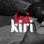 Maori lowercase font for 'toi kiri' indigenous arts festival, red and white logo on black and white image of ta moko artist