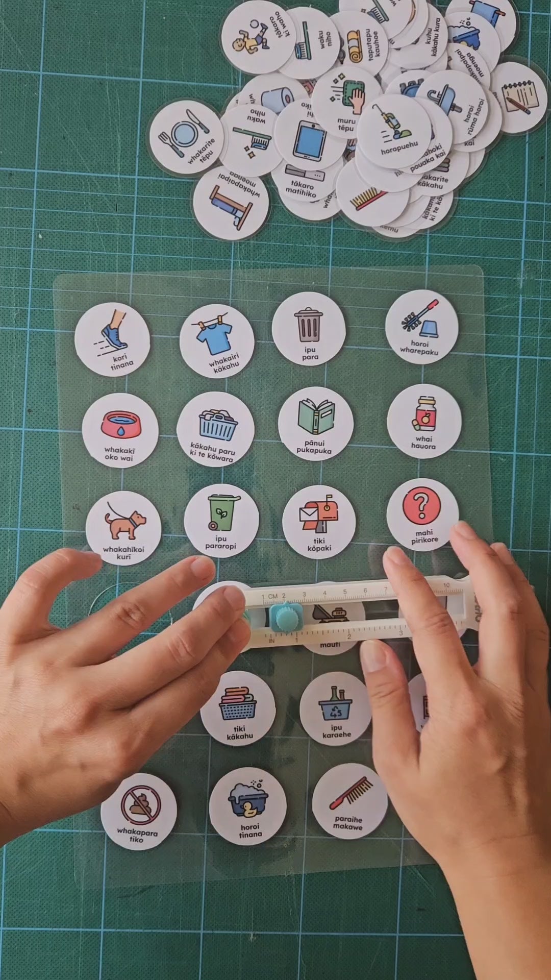 circle cutter tool cutting out small round routine cards in te reo Māori