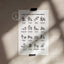A printed sheet with te reo Māori dog commands displayed on it, placed on a surface with a shadow falling over it.